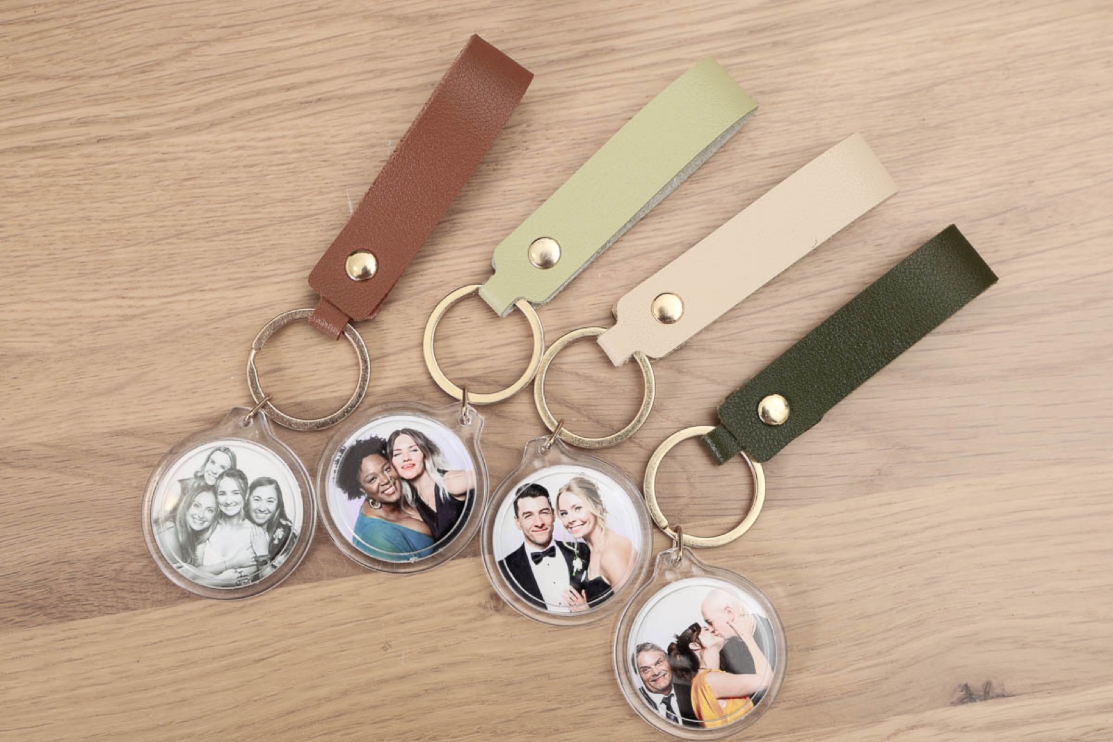 Double-sided photo keychains on leather straps from a wedding reception